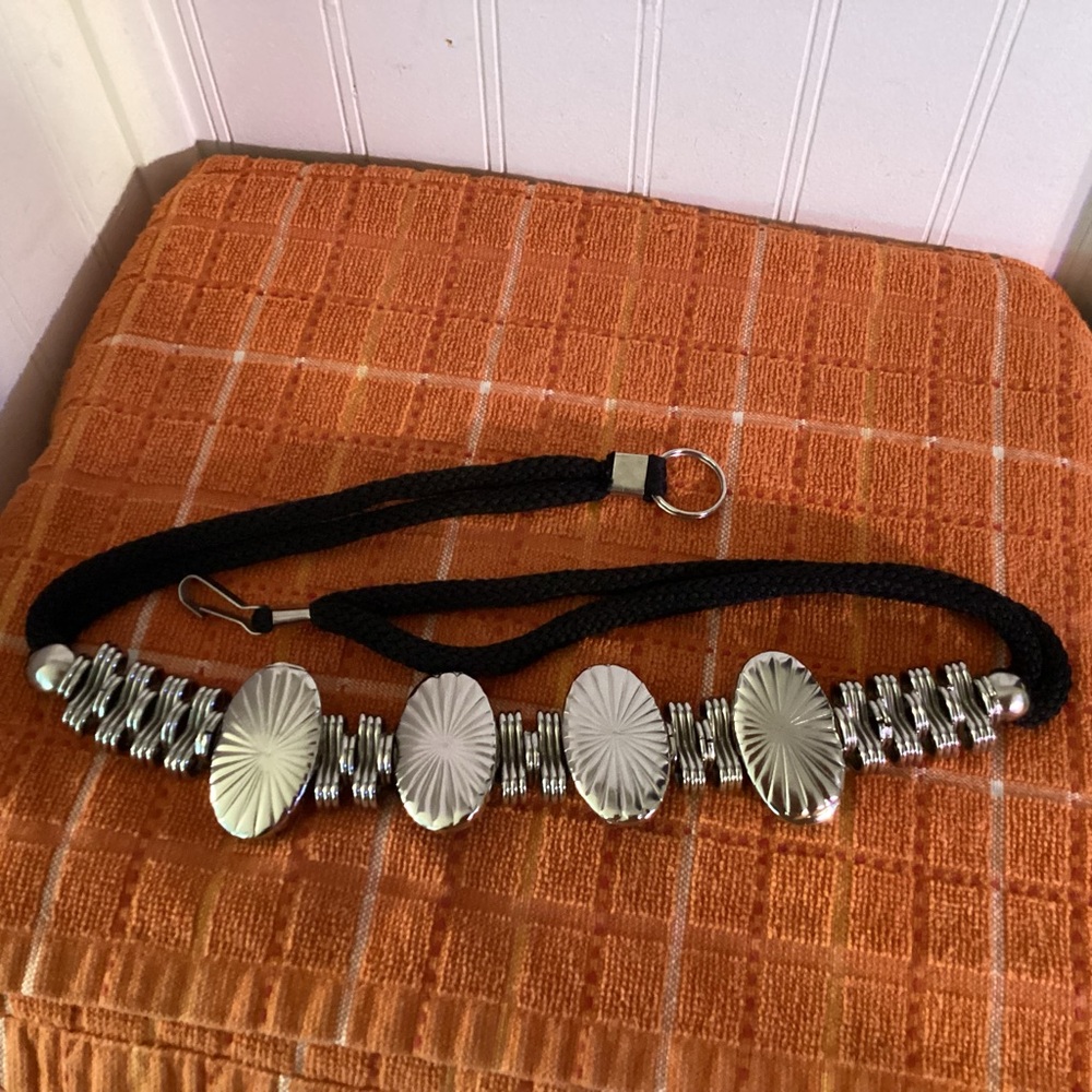 Black Cord Stainless Steel “Concho” Design Belt, 29 1/2”.  Hooks in the back.